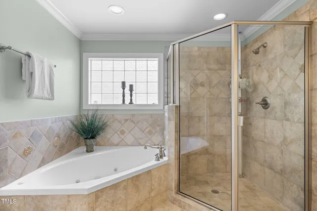 a bedroom with a bed mirror and window