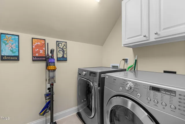 a bathroom with a double vanity sink mirror and toilet