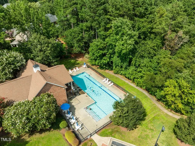 an aerial view of a house with a yard and trees