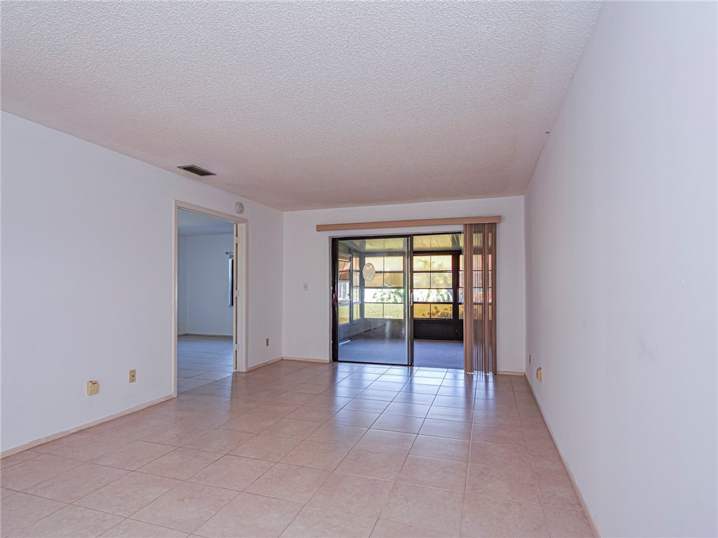 6006 Indrio Road, Unit B4 Fort Pierce, FL 34951 - Photo 11 of 36 an empty room with windows