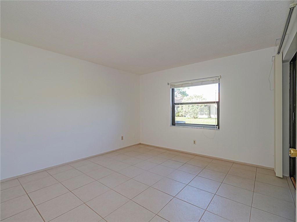 6006 Indrio Road, Unit B4 Fort Pierce, FL 34951 - Photo 15 of 36 an empty room with windows