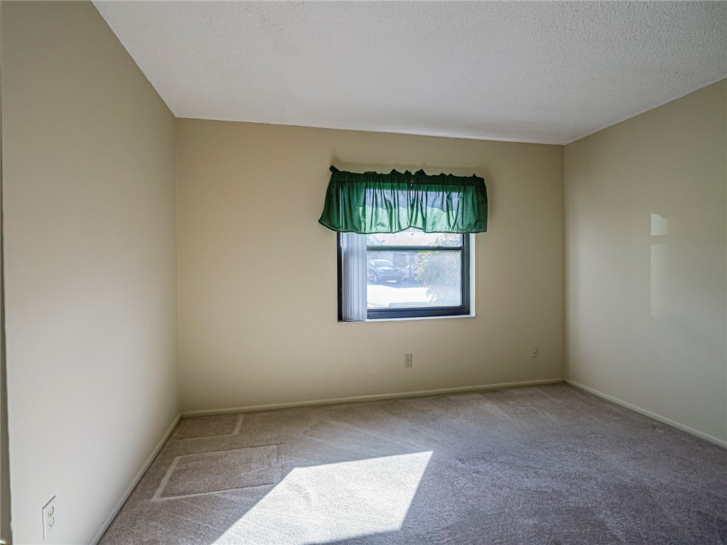 6006 Indrio Road, Unit B4 Fort Pierce, FL 34951 - Photo 21 of 36 an empty room with a window