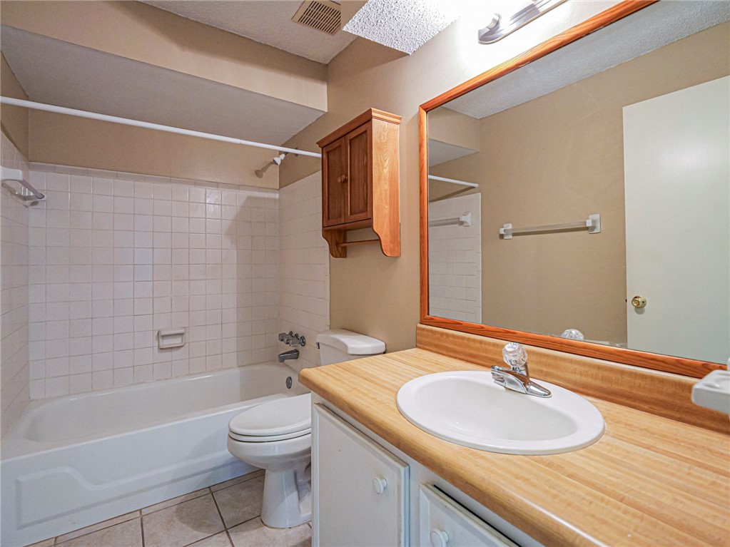 6006 Indrio Road, Unit B4 Fort Pierce, FL 34951 - Photo 26 of 36 a bathroom with a granite countertop sink toilet a mirror and shower