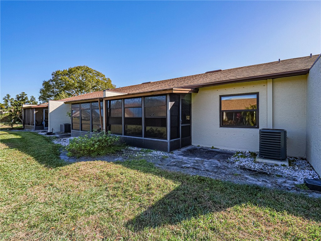 6006 Indrio Road, Unit B4 Fort Pierce, FL 34951 - Photo 30 of 36 a view of a house with a small yard and a large window