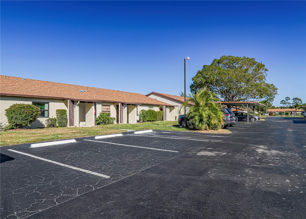 6006 Indrio Road, Unit B4 Fort Pierce, FL 34951 - Photo 3 of 36 a view of street with large trees