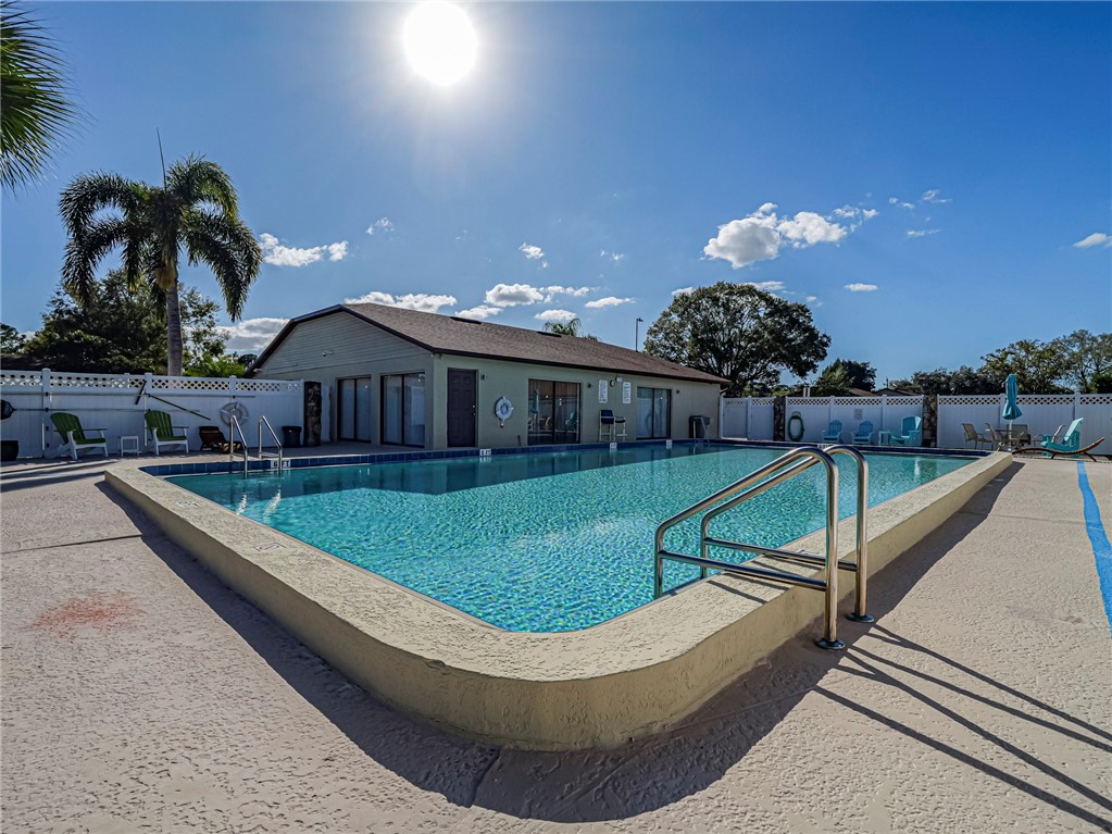 6006 Indrio Road, Unit B4 Fort Pierce, FL 34951 - Photo 33 of 36 a view of a house with swimming pool and sitting area