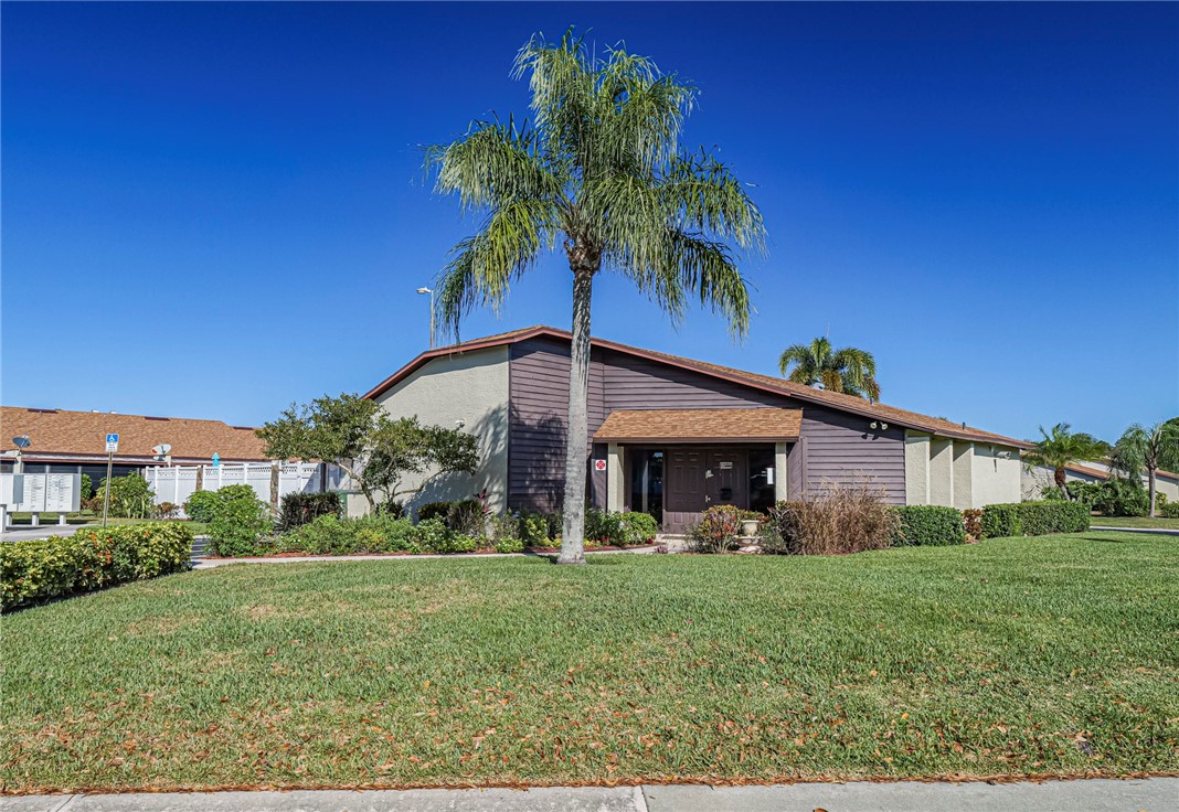 6006 Indrio Road, Unit B4 Fort Pierce, FL 34951 - Photo 36 of 36 a front view of a house with garden