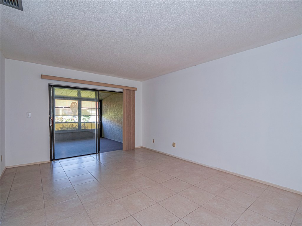 6006 Indrio Road, Unit B4 Fort Pierce, FL 34951 - Photo 10 of 36 a view of an empty room with a window