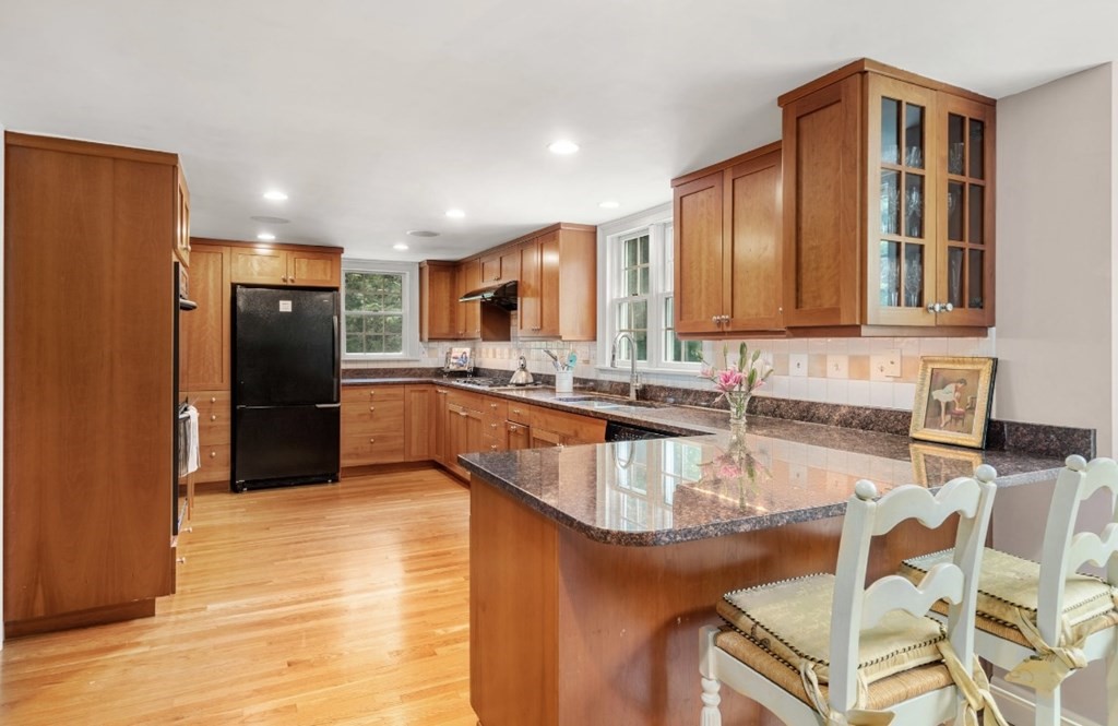 217 Conant Road Weston, MA 02493 - Photo 11 of 30 a large kitchen with granite countertop a sink and cabinets