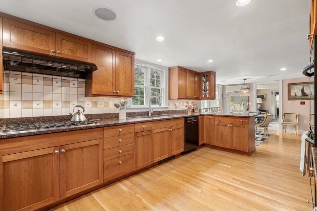 217 Conant Road Weston, MA 02493 - Photo 13 of 30 a large kitchen with stainless steel appliances wooden cabinets a sink and a stove