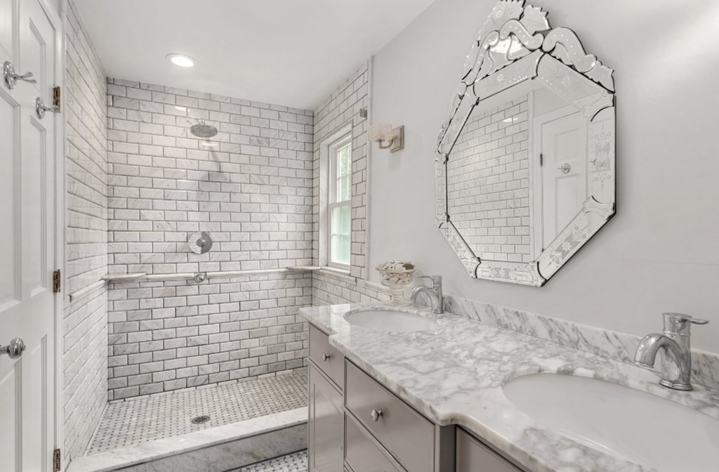 217 Conant Road Weston, MA 02493 - Photo 20 of 30 a bathroom with a granite countertop sink a mirror and shower