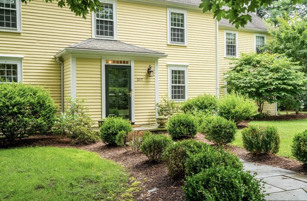 217 Conant Road Weston, MA 02493 - Photo 2 of 30 a view of a house with a yard and potted plants