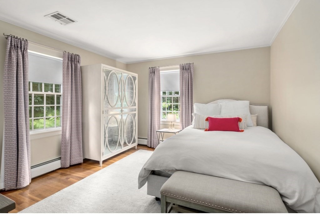 217 Conant Road Weston, MA 02493 - Photo 21 of 30 a bedroom with a large bed and a window