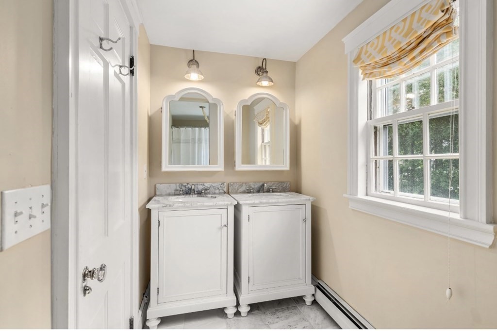 217 Conant Road Weston, MA 02493 - Photo 23 of 30 a bathroom with a granite countertop sink and a mirror