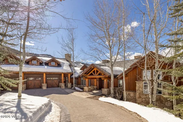 a front view of a house with a yard and potted plants
