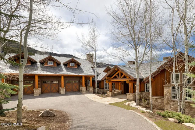 a dining room with furniture a chandelier and wooden floor