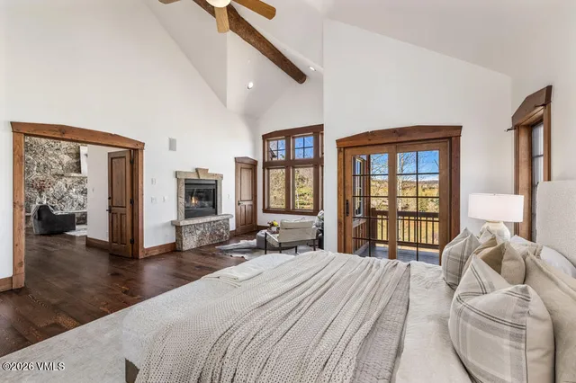 a bedroom with a bed and a large window