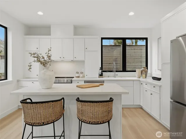 a large kitchen with a sink and refrigerator