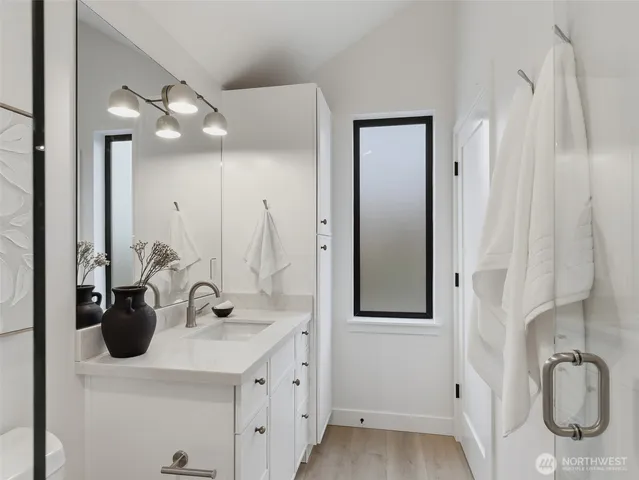 a bedroom with bed a lamp and a window