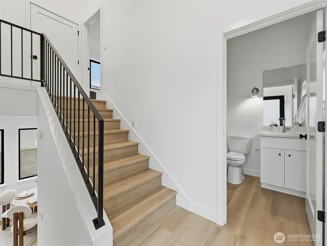 a bathroom with a toilet sink and mirror