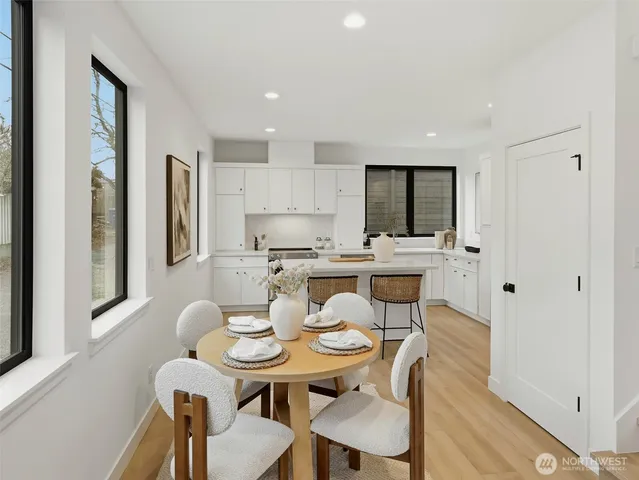 a kitchen with stainless steel appliances granite countertop a sink and white cabinets