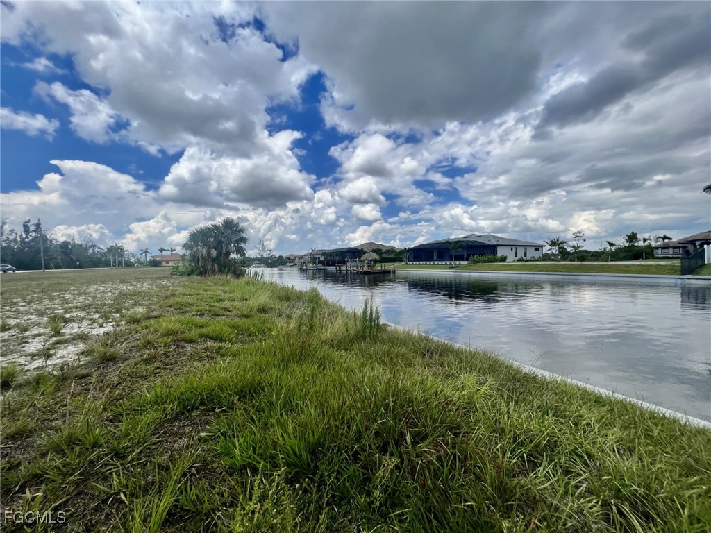 2131 Old Burnt Store Road North Cape Coral, FL 33993 - Photo 2 of 6 a view of a lake with houses in the back