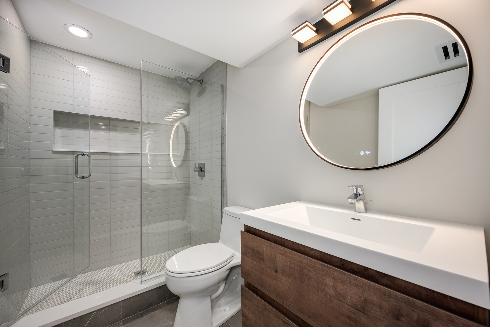 2225 West Carmen Avenue Chicago, IL 60625 - Photo 26 of 45 a bathroom with a sink toilet and a mirror