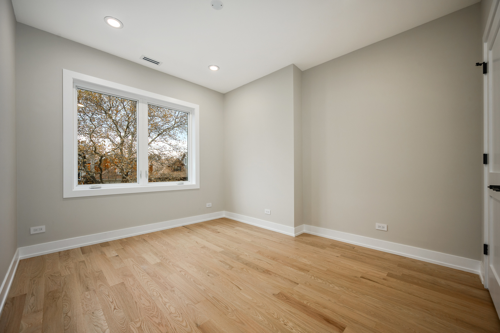 2225 West Carmen Avenue Chicago, IL 60625 - Photo 28 of 45 an empty room with wooden floor and windows