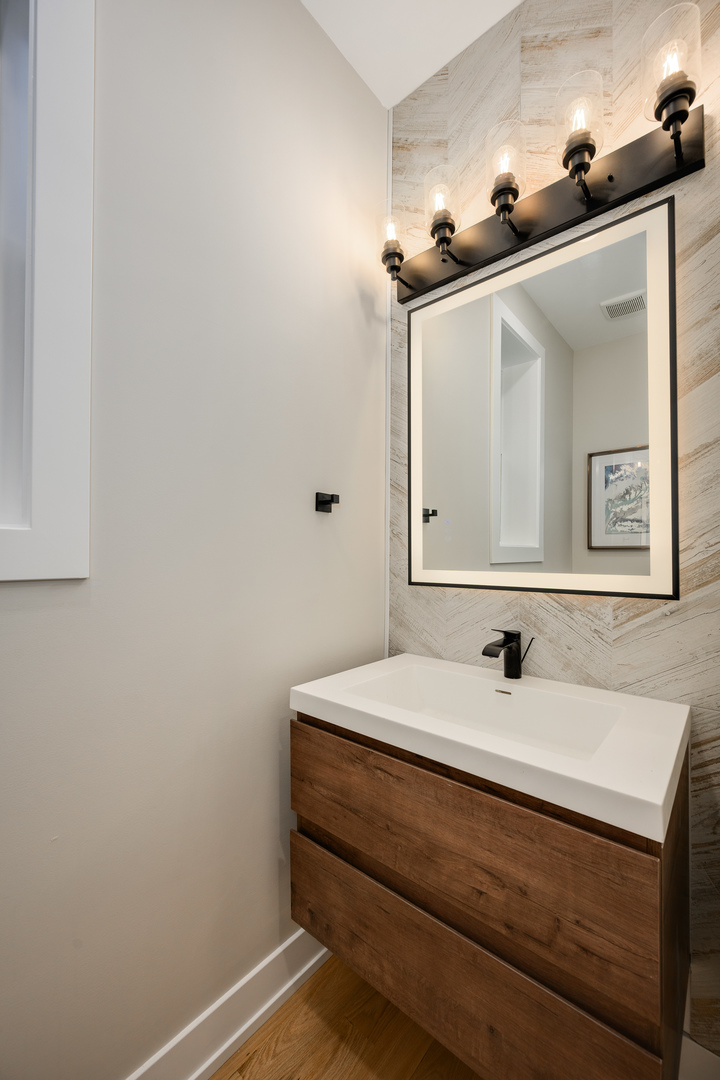 2225 West Carmen Avenue Chicago, IL 60625 - Photo 10 of 45 a bathroom with a sink and a mirror