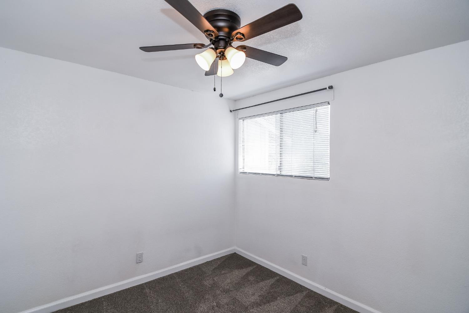 1139 Rivara Circle Sacramento, CA 95864 - Photo 31 of 72 an empty room with a window and a fan