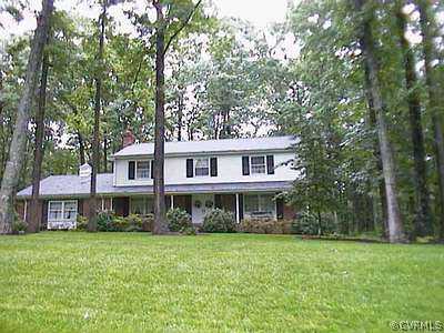 2721 East Brigstock Road Midlothian, VA 23113 - Photo 1 of 1 a front view of a house with a garden and trees