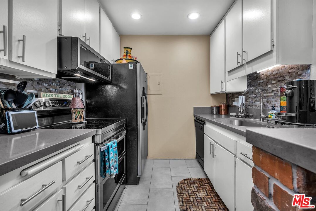 7740 Redlands Street, Unit G3092 Playa del Rey, CA 90293 - Photo 17 of 37 a kitchen with stainless steel appliances granite countertop a sink stove and refrigerator