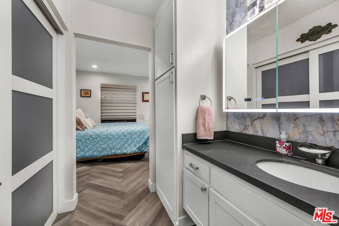 7740 Redlands Street, Unit G3092 Playa del Rey, CA 90293 - Photo 23 of 37 a en suite bathroom with a granite countertop sink and a mirror