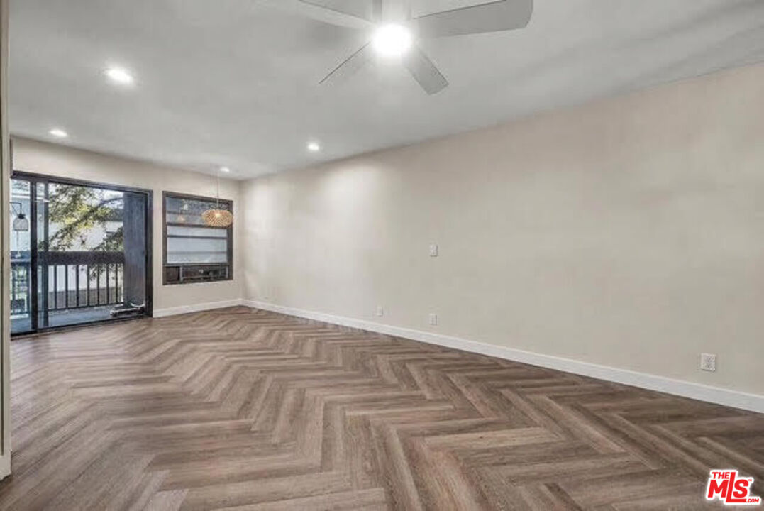 7740 Redlands Street, Unit G3092 Playa del Rey, CA 90293 - Photo 7 of 37 a view of an empty room with a window and wooden floor