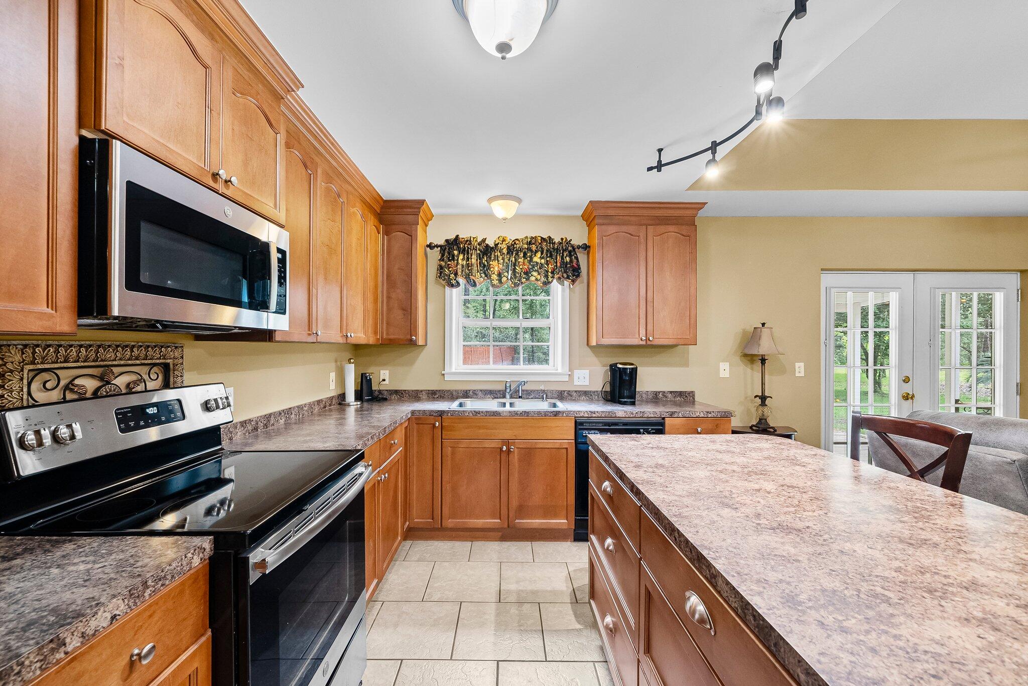 107 Rodney Drive Freeport, FL 32439 - Photo 11 of 34 a kitchen with a stove a sink and a microwave