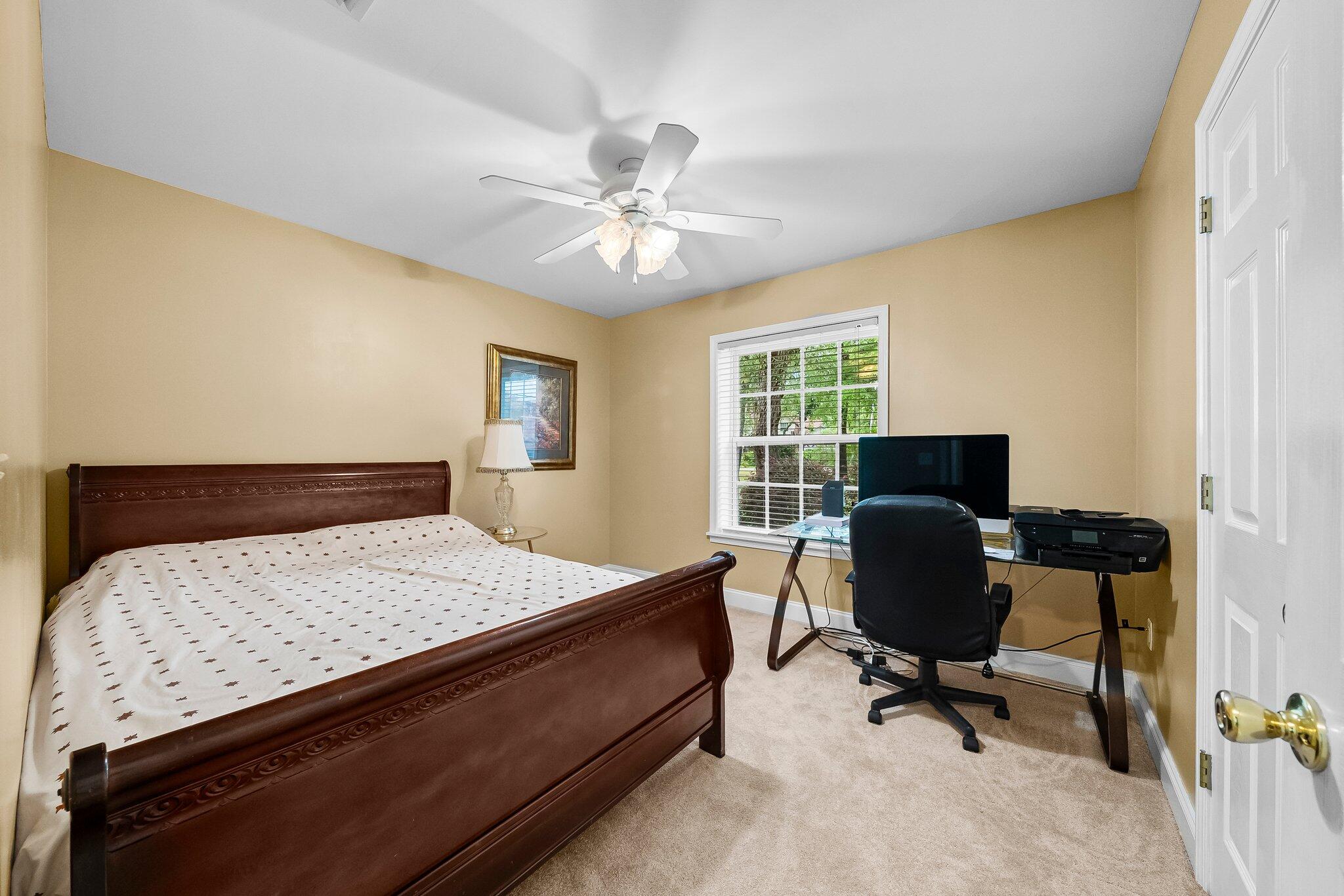 107 Rodney Drive Freeport, FL 32439 - Photo 14 of 34 a bedroom with a bed and a desk