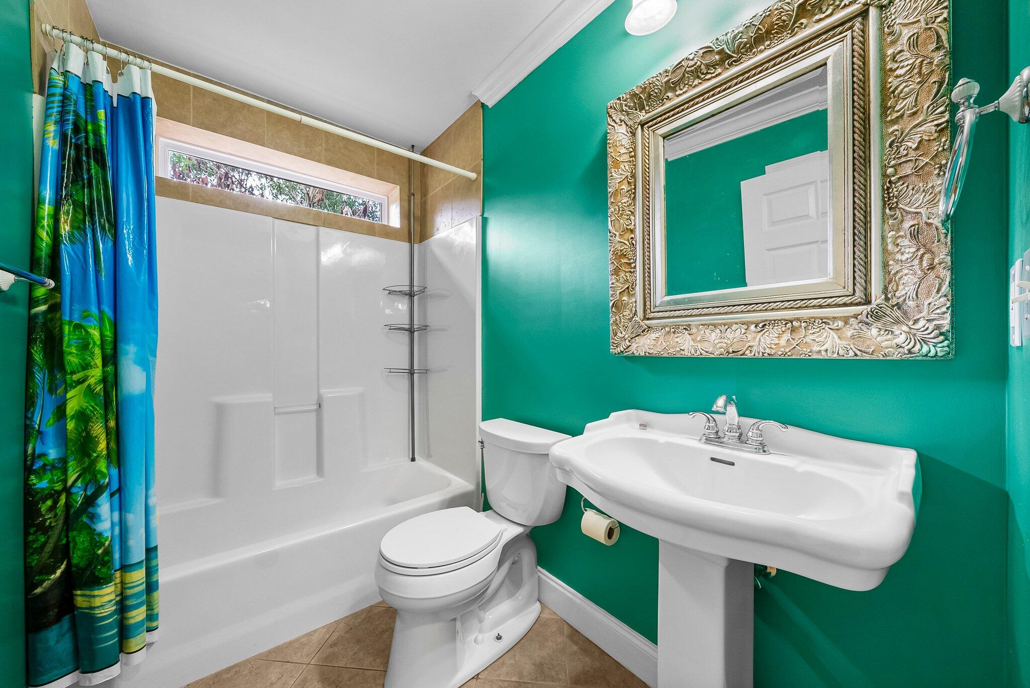 107 Rodney Drive Freeport, FL 32439 - Photo 16 of 34 a bathroom with a sink a toilet and shower