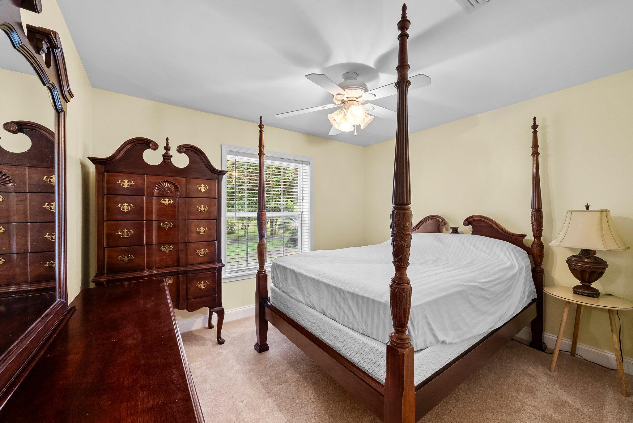 107 Rodney Drive Freeport, FL 32439 - Photo 18 of 34 a bed room with a bed and a lamp