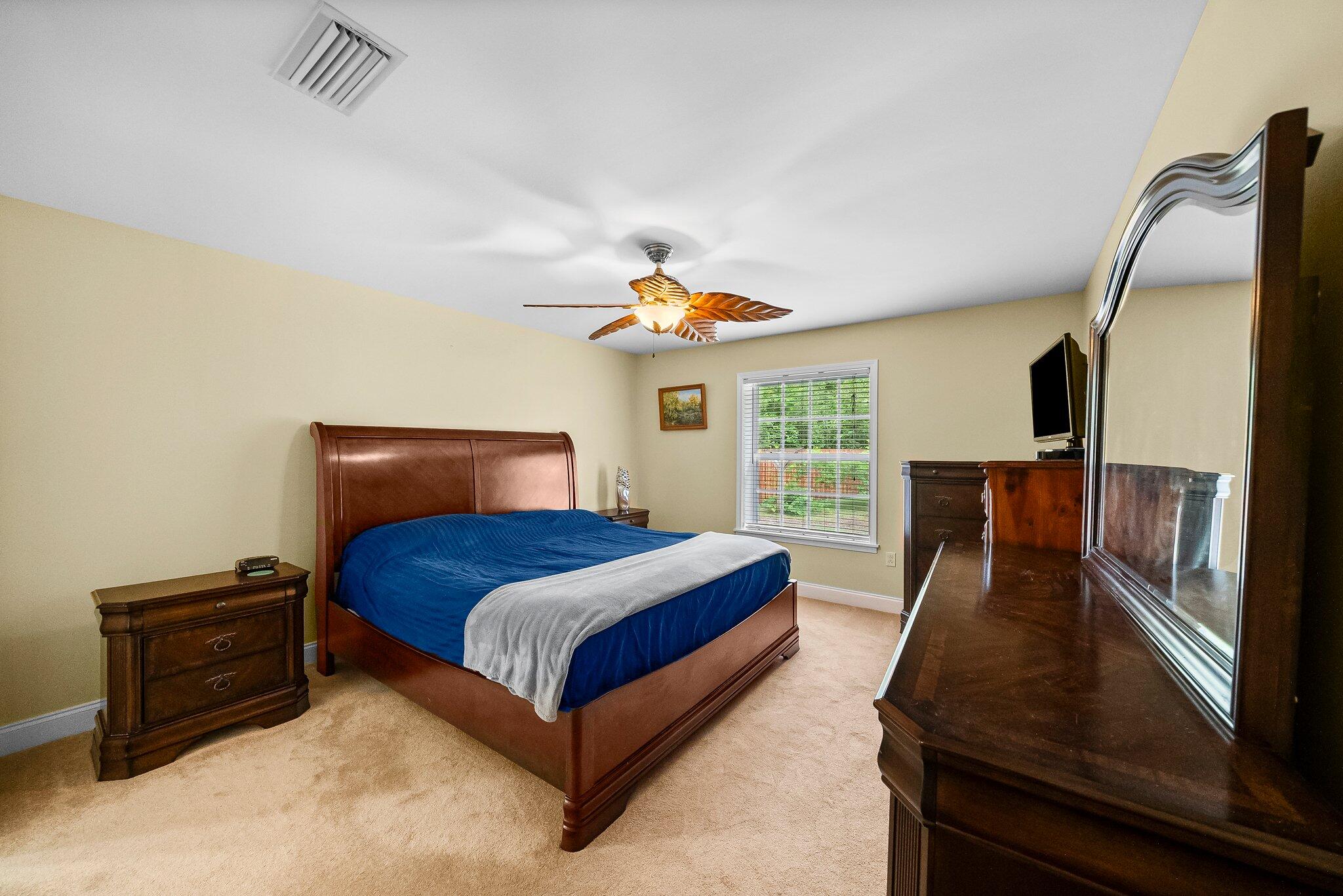 107 Rodney Drive Freeport, FL 32439 - Photo 20 of 34 a bedroom with a bed and wooden floor