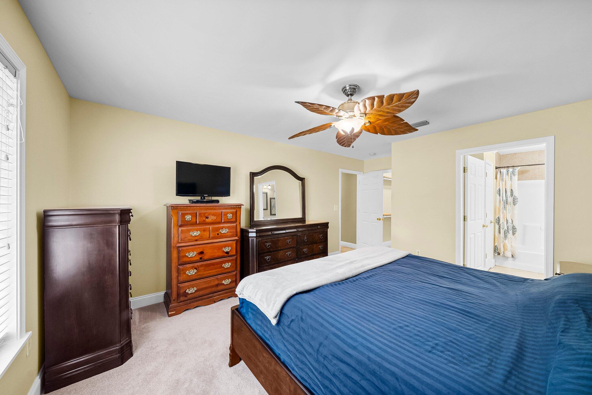 107 Rodney Drive Freeport, FL 32439 - Photo 21 of 34 a bedroom with a bed and a chandelier