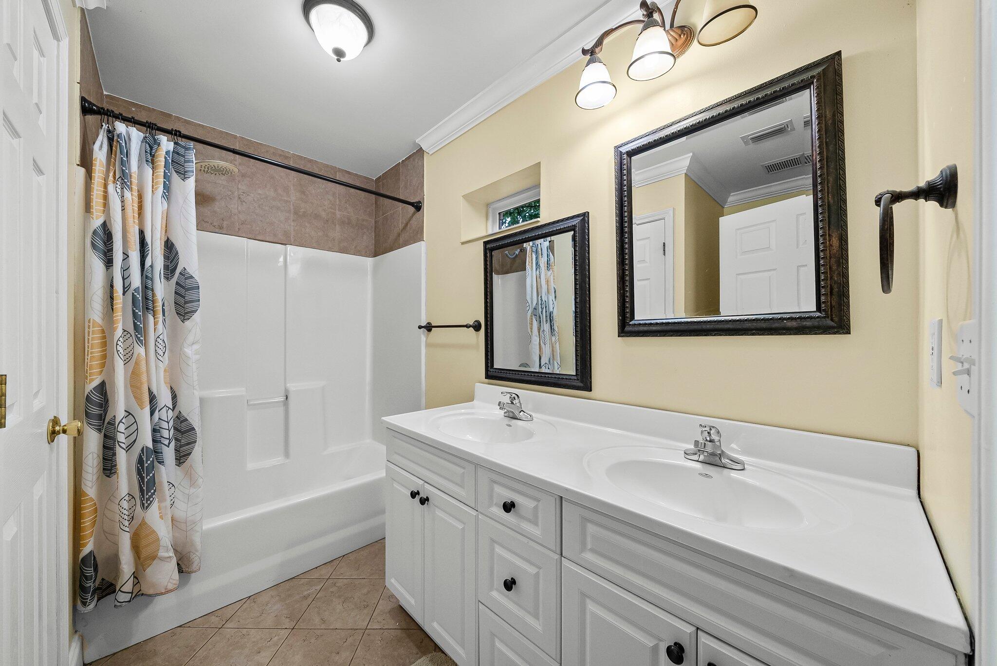 107 Rodney Drive Freeport, FL 32439 - Photo 23 of 34 a bathroom with a double vanity sink mirror and shower