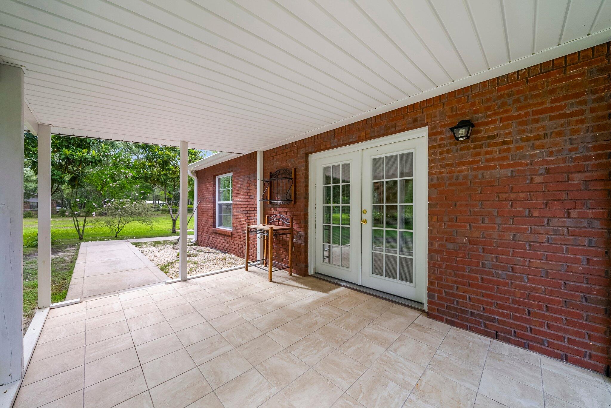 107 Rodney Drive Freeport, FL 32439 - Photo 24 of 34 a view of backyard with a garden and porch
