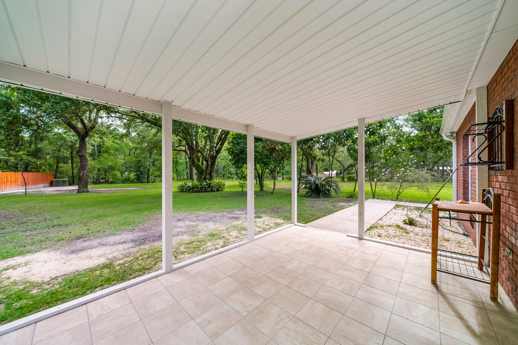 107 Rodney Drive Freeport, FL 32439 - Photo 25 of 34 a view of a house with backyard and a backyard