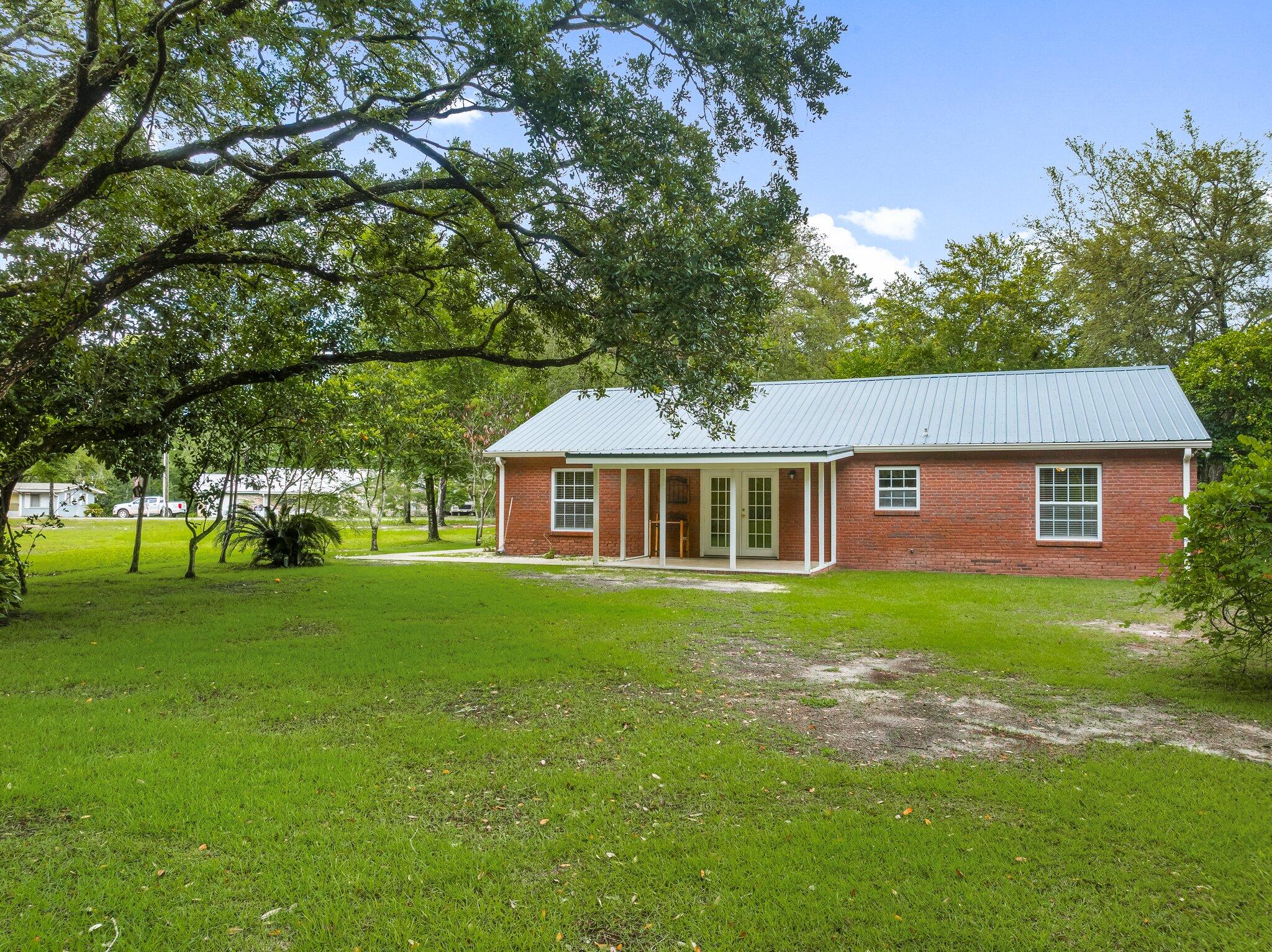 107 Rodney Drive Freeport, FL 32439 - Photo 27 of 34 a front view of a house with garden