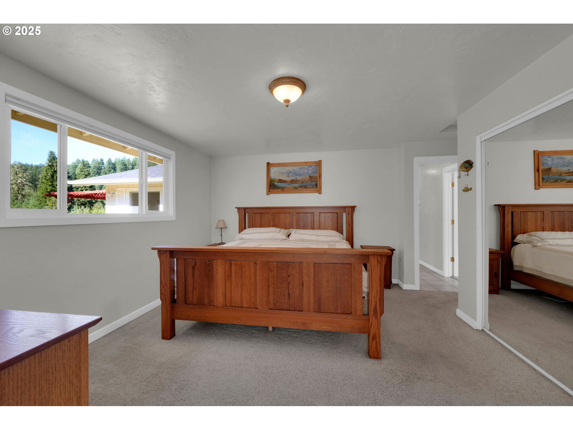 89550 Dick Way Florence, OR 97439 - Photo 13 of 39 a bedroom with a bed and a night stand