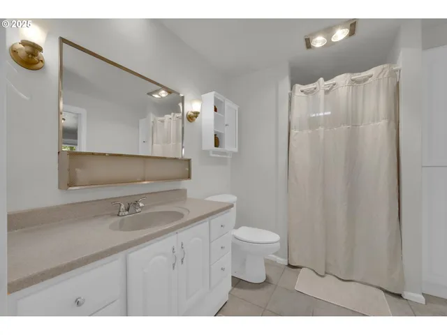 a bathroom with a toilet a sink and a mirror