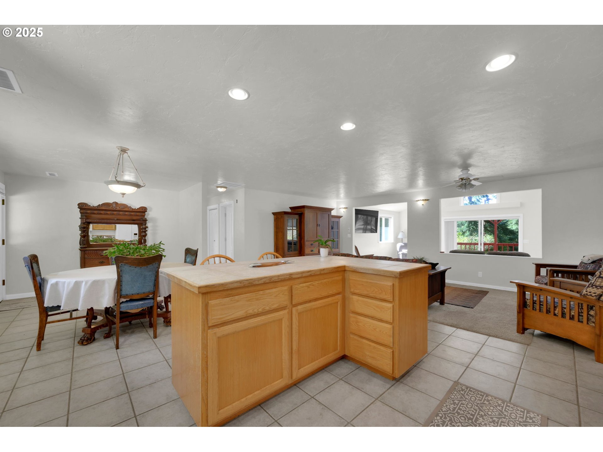 89550 Dick Way Florence, OR 97439 - Photo 10 of 39 a large white kitchen with stainless steel appliances granite countertop a sink dishwasher a dining table and chair with wooden floor