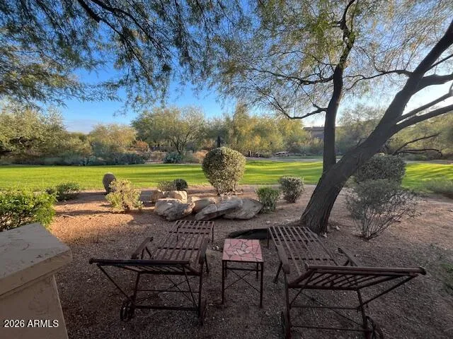 a view of a yard with furniture and garden