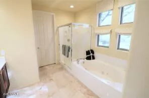 a bathroom with a bathtub and a shower