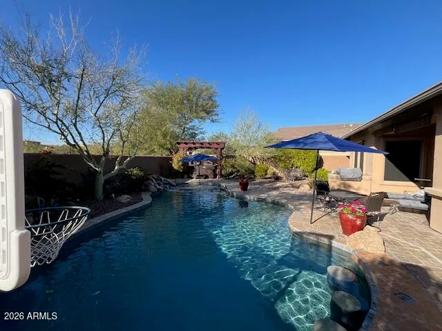 a view of a patio with table and chairs and potted plants